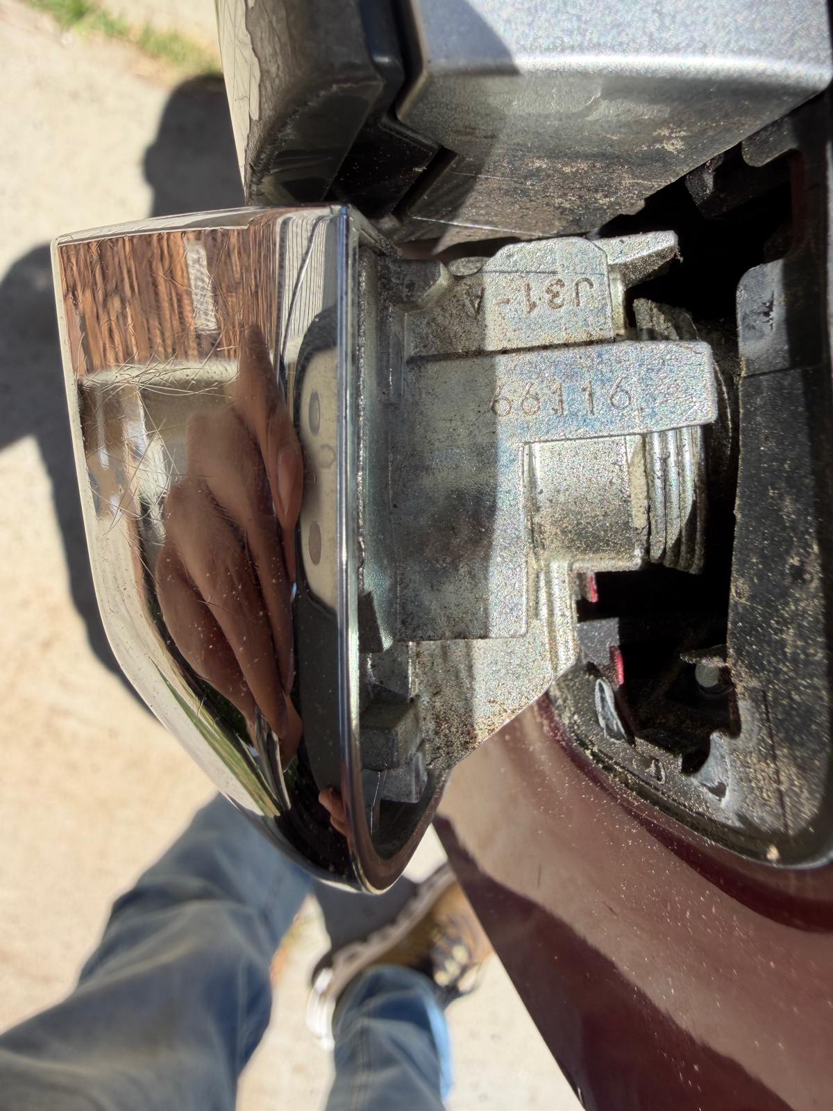 Close-up of a car door handle cylinder lock showing lock code digits for professional key replacement during a custom Locksmith Services job in Charlotte, NC