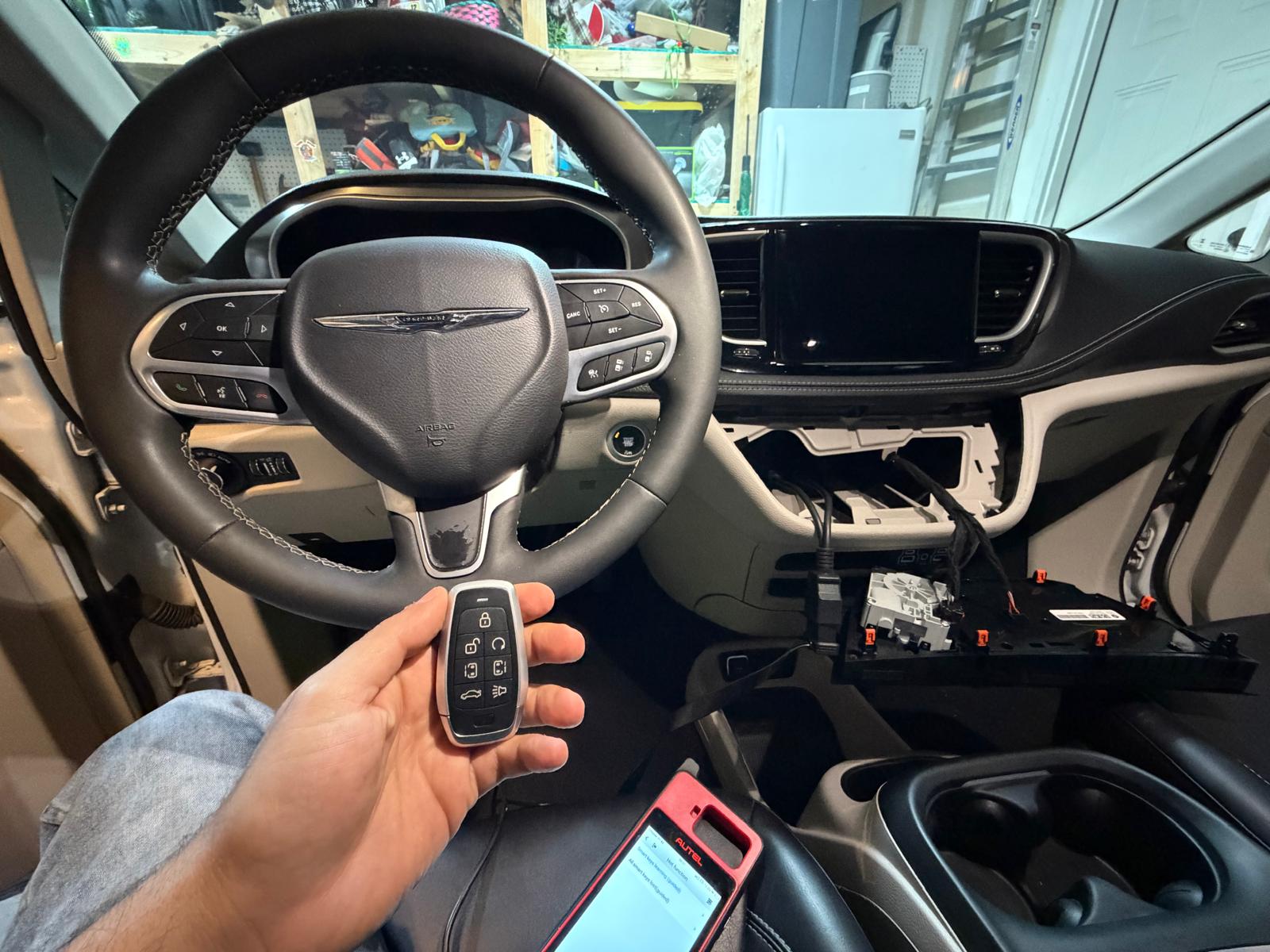 Chrysler minivan dashboard panel disassembled during transponder key programming using Autel tablet device in Charlotte, NC NC