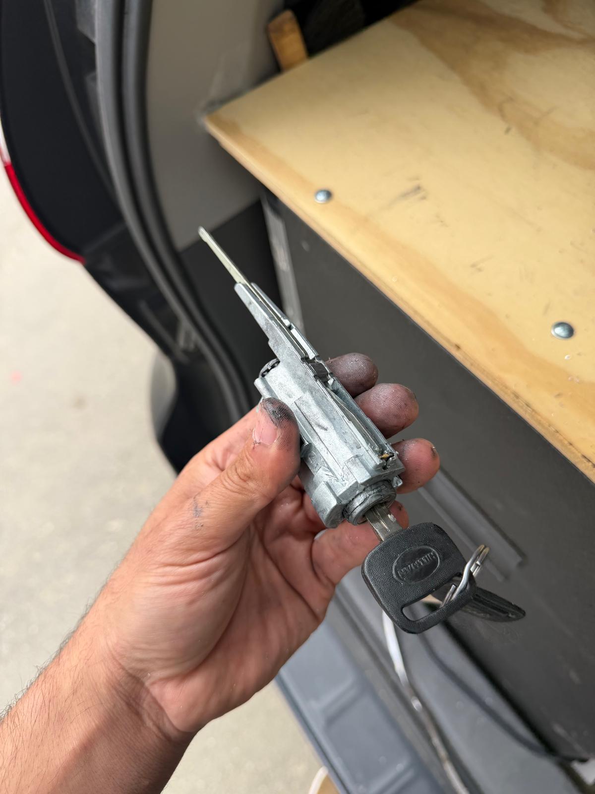 Rebuilt car ignition switch lock cylinder holding a mechanical key in Charlotte, NC NC