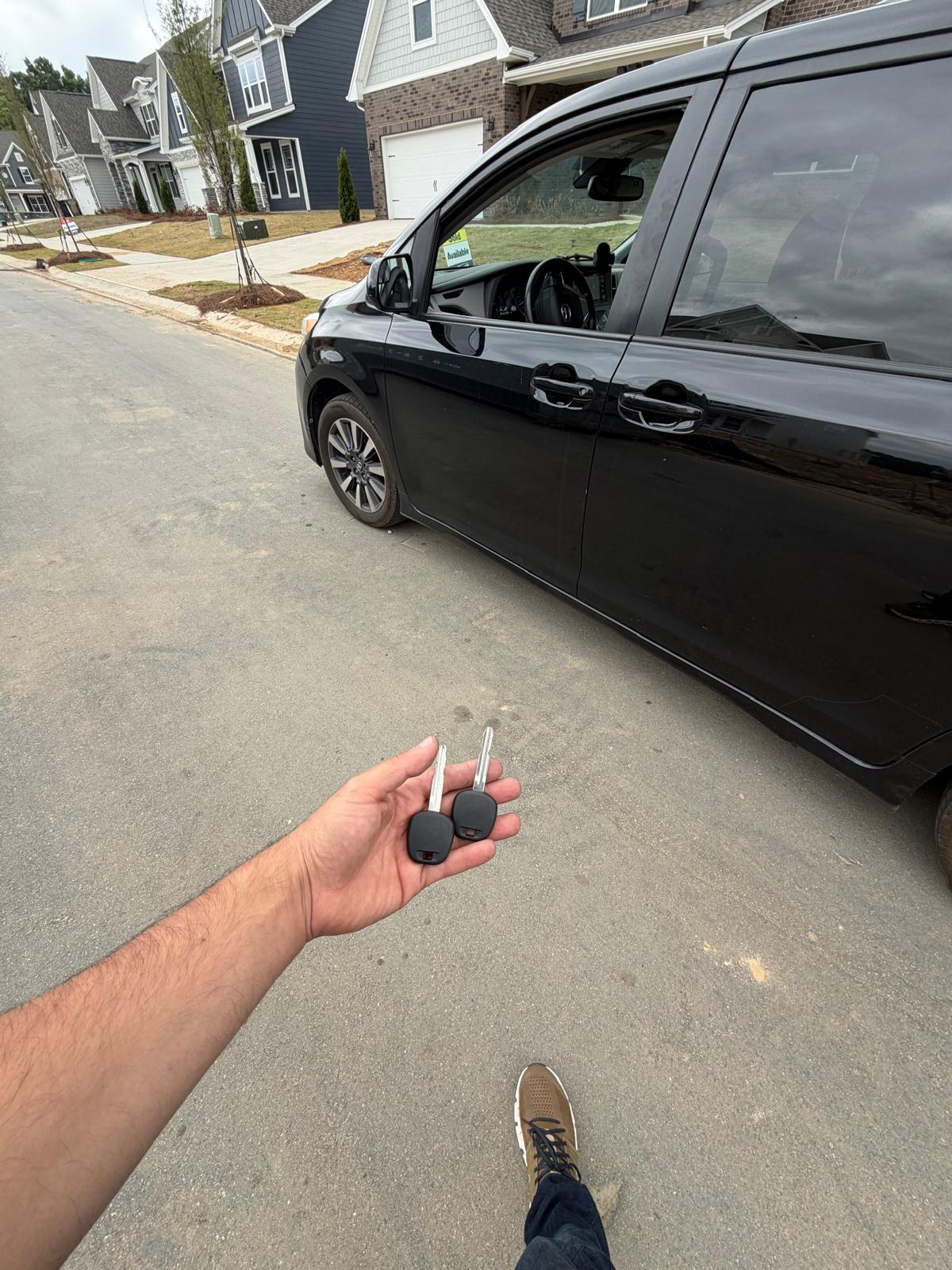 New keys cut and programmed for a black Toyota Sienna minivan in a residential neighborhood during a custom Automotive Key & Lock Work job in Charlotte, NC